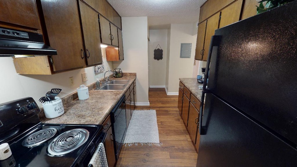 a kitchen with a stove refrigerator and a sink