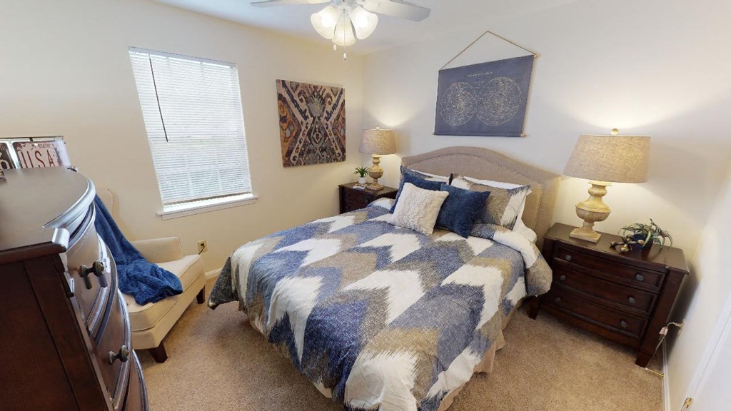 a bedroom with a bed and a ceiling fan