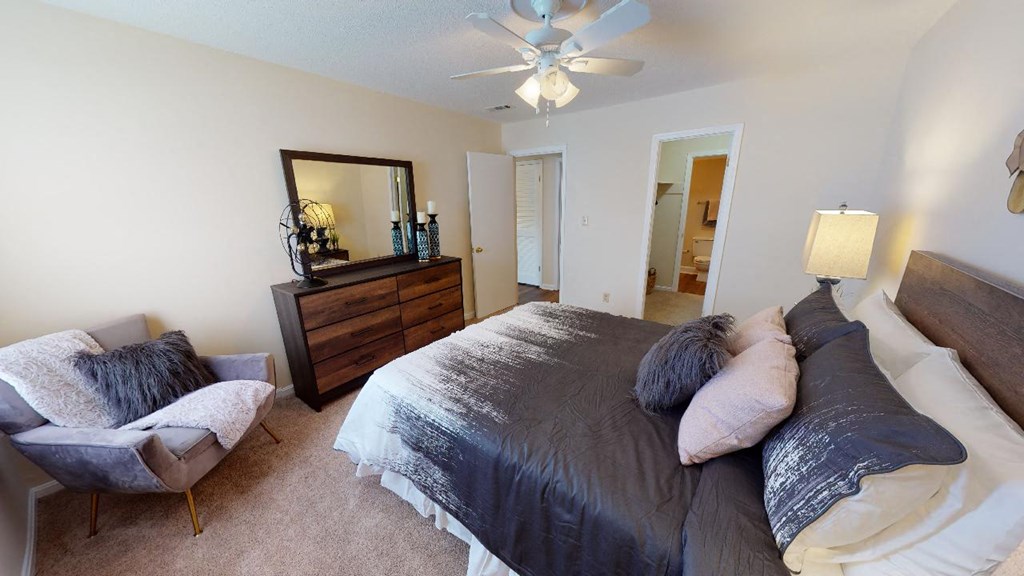 a bedroom with a bed and a ceiling fan