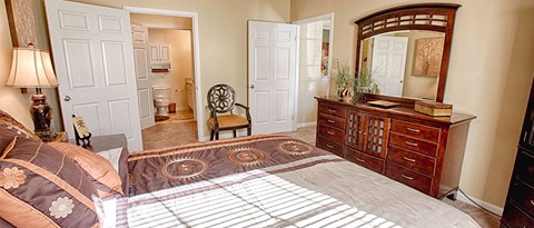 a bedroom with a bed and a dresser