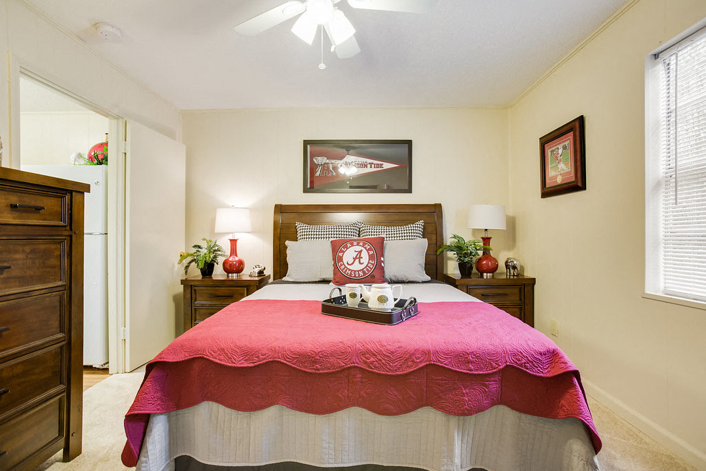 a bedroom with a bed and a ceiling fan