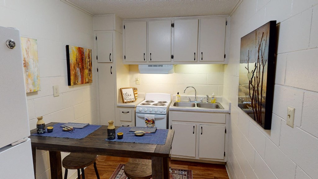 a kitchen with white cabinets and a table