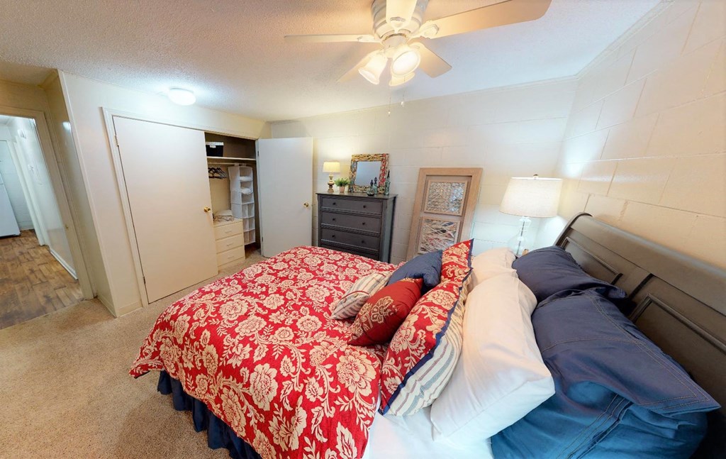 a bedroom with a bed and a ceiling fan