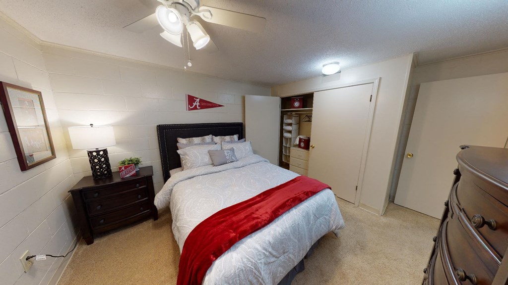 a bedroom with a bed and a ceiling fan