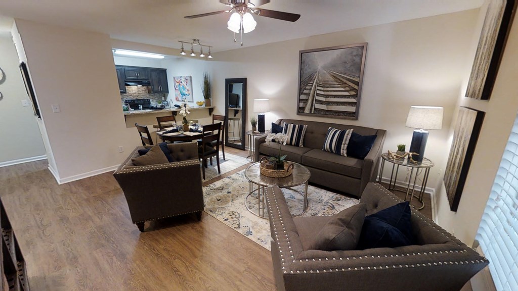 a living room with couches and chairs and a dining room table