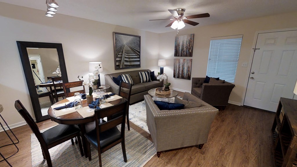 a living room and dining room with a couch and a table