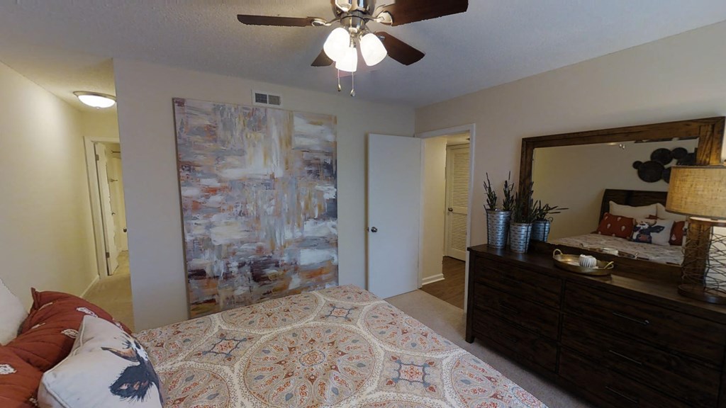 a bedroom with a bed and a ceiling fan