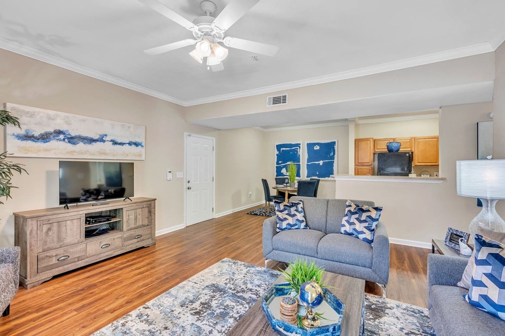 a living room with furniture and a ceiling fan