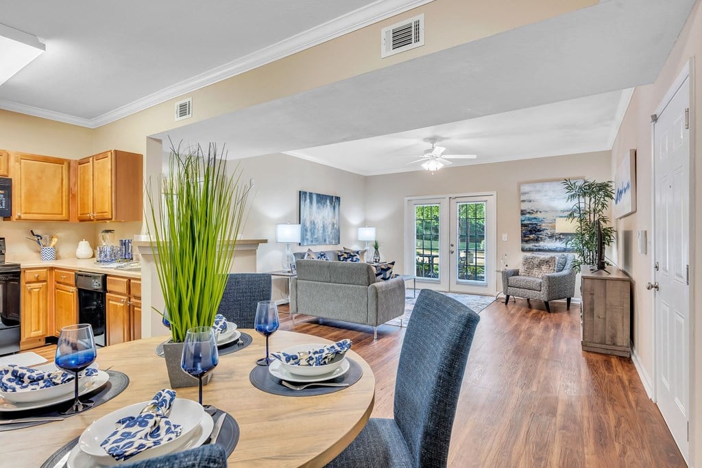 a living room and dining room with a table and chairs