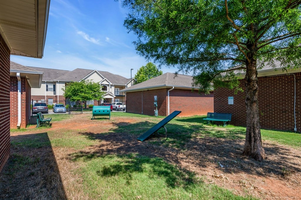 our apartments have a park with a tree and benches