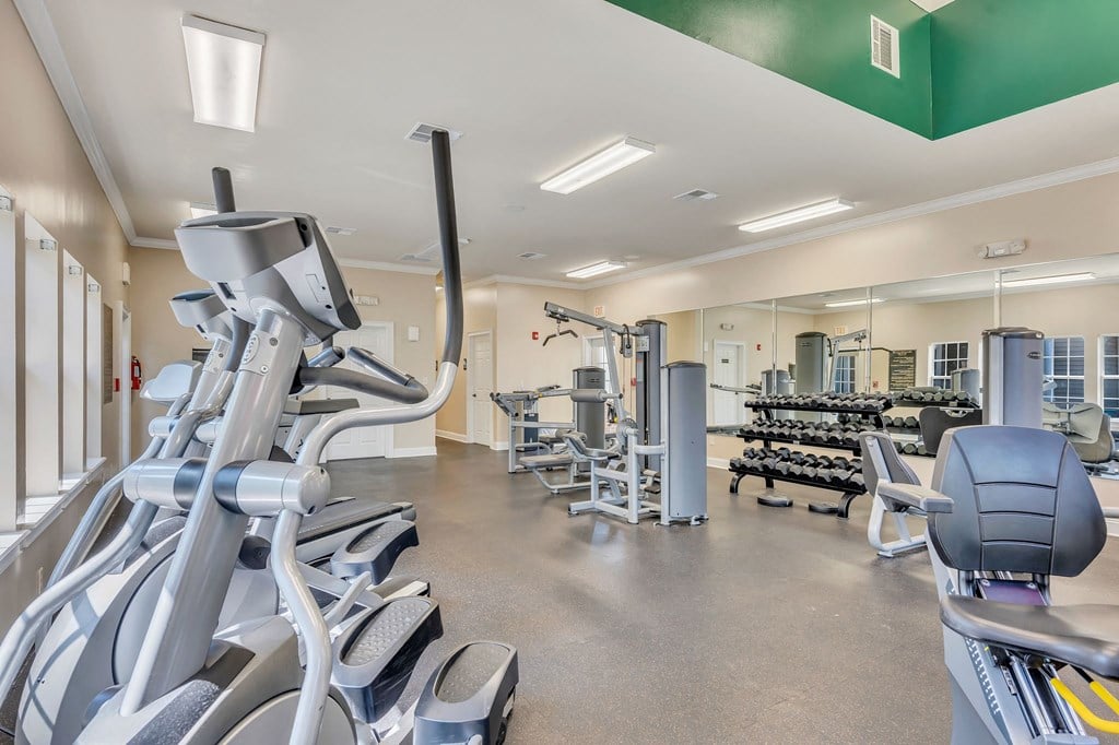 a gym with cardio equipment and weights at the village