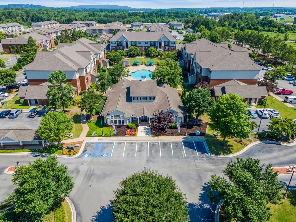 an aerial view of a neighborhood of houses with a swimming pool
