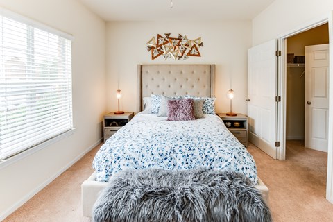 a bedroom with a bed and a window