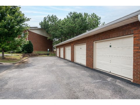 a row of garages in front of a brick building