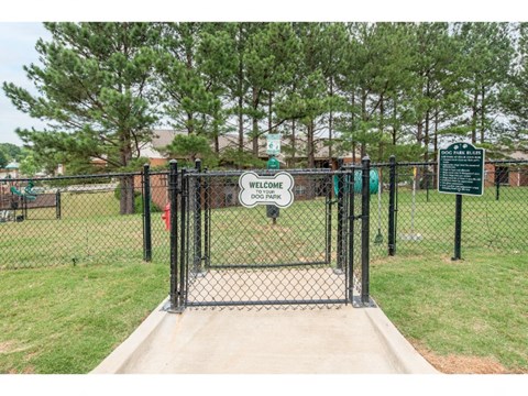 a dog park with a dog kennel and a sign that says hello kitty