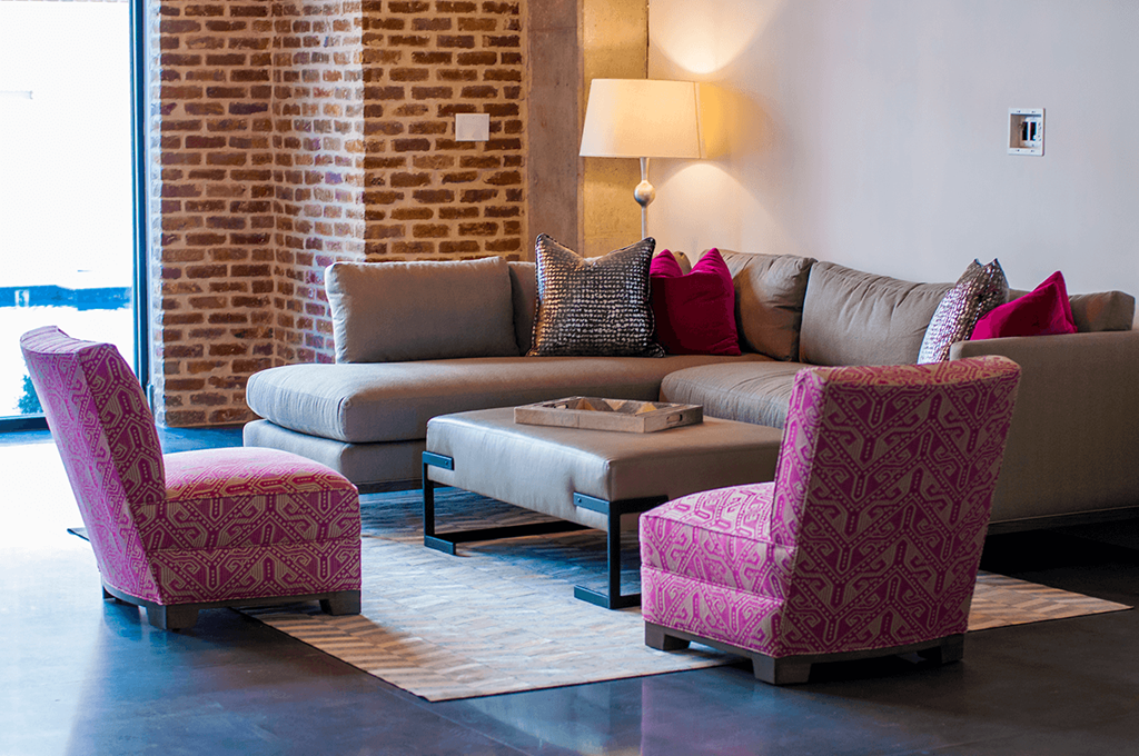 a living room with a couch and two chairs