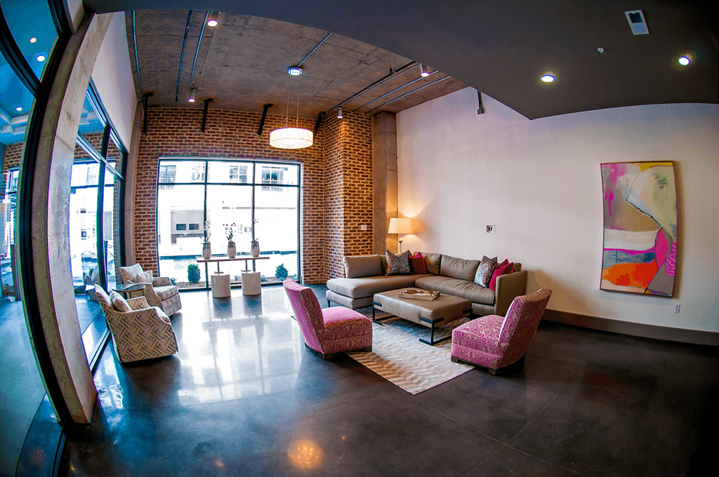a living room with couches and chairs and a large window