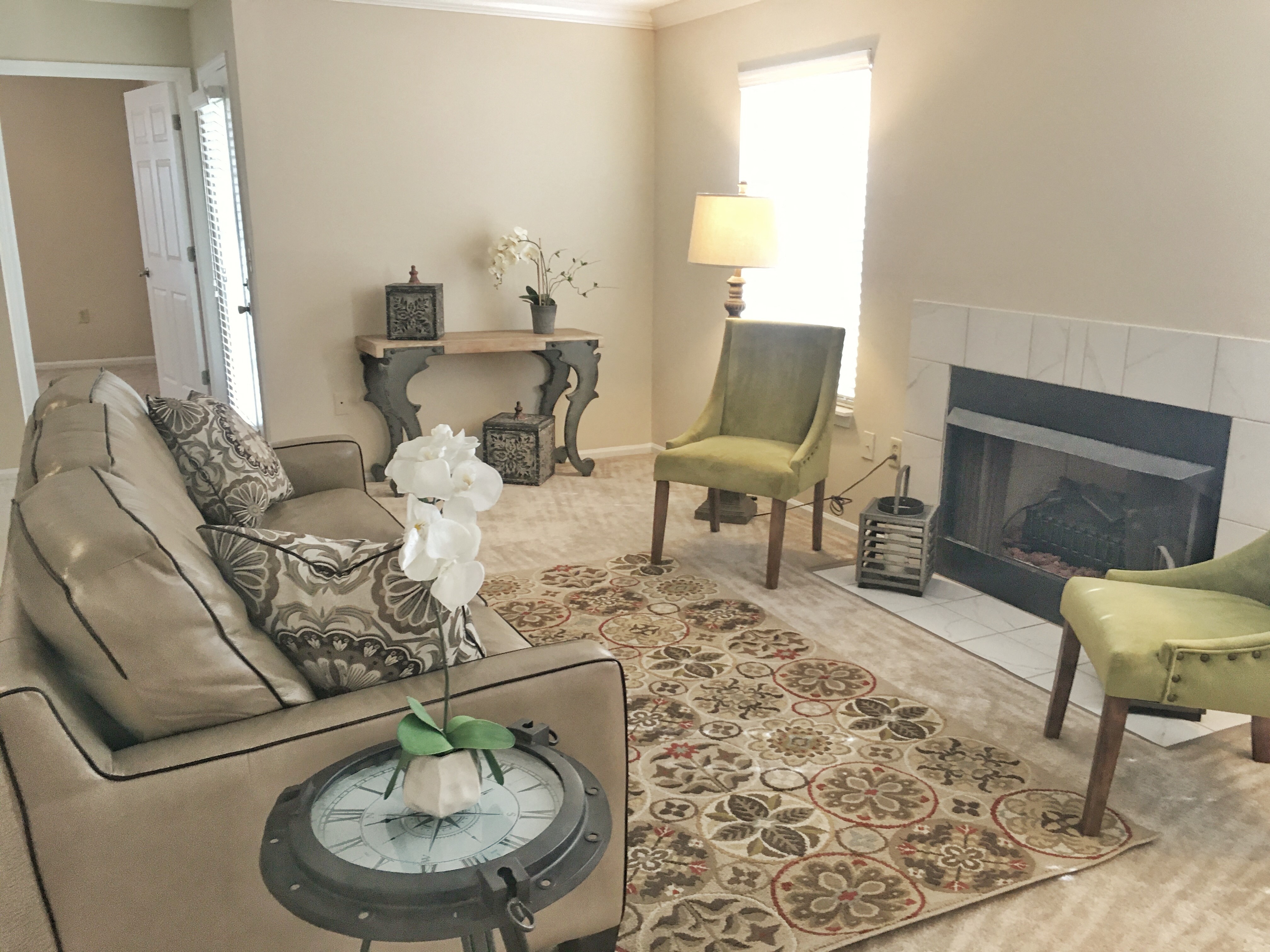 a living room with a fireplace and a rug