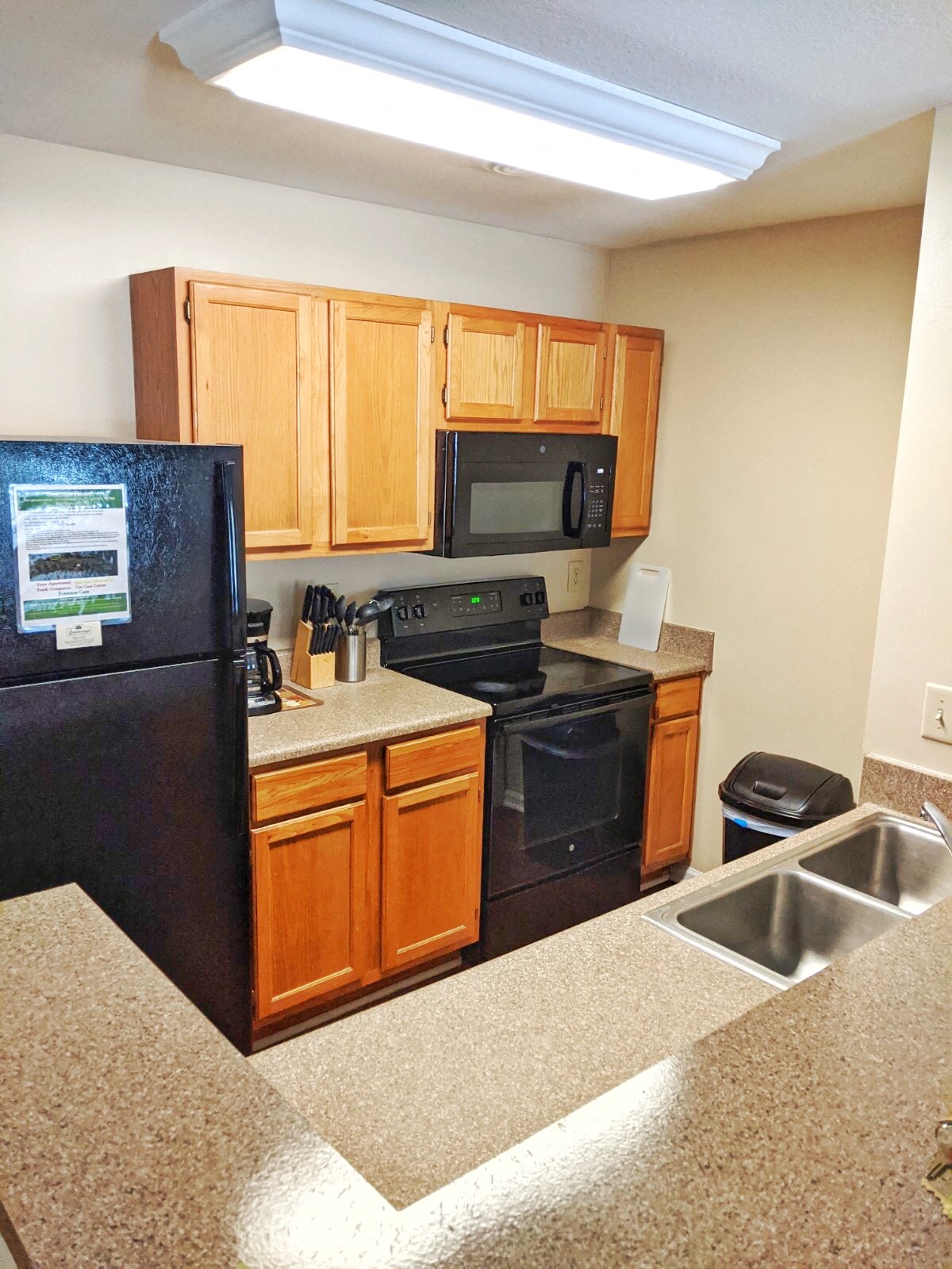 a kitchen with black appliances and wooden cabinets