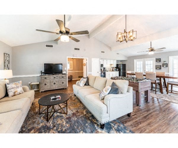 a living room and dining room with couches and a table