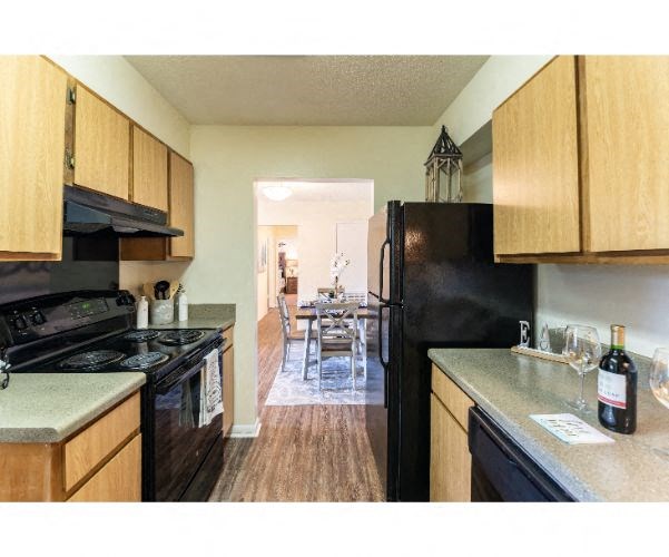 a kitchen with a stove and a refrigerator and a table