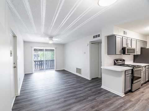 A kitchen with a white countertop and stainless steel appliances.