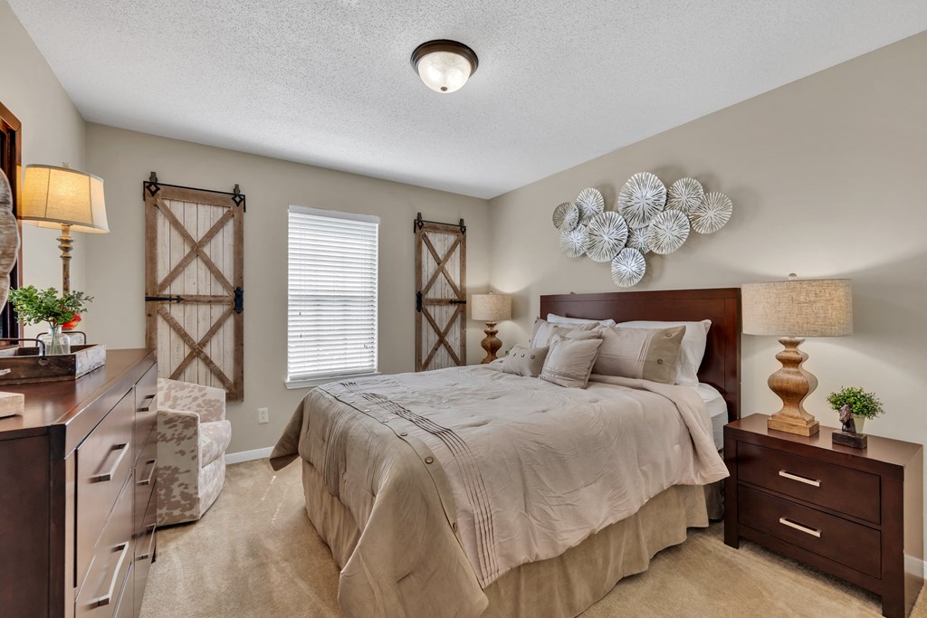 a bedroom with a bed and a dresser and a window