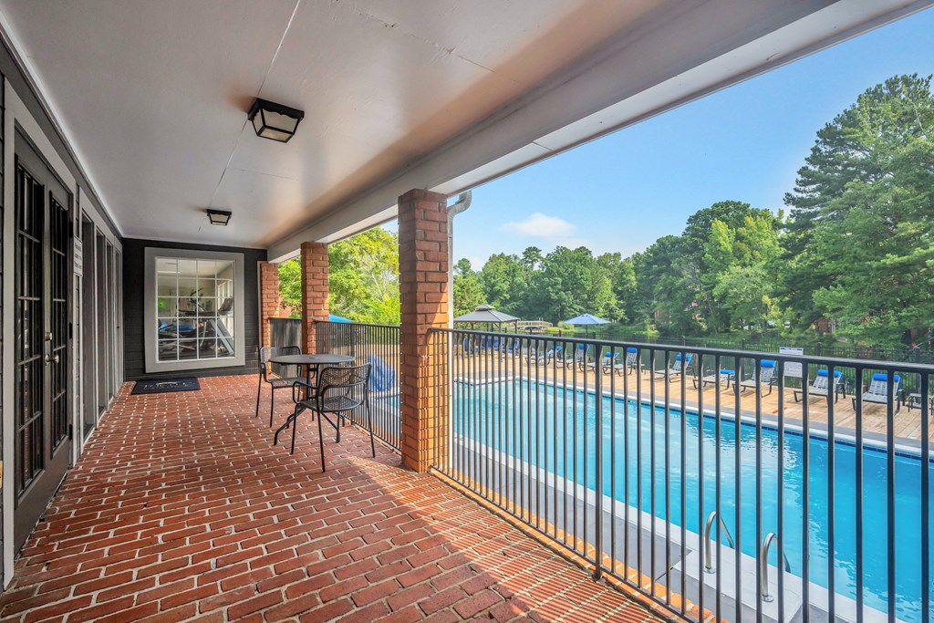 the view of the pool from the balcony of a house with a swimming pool