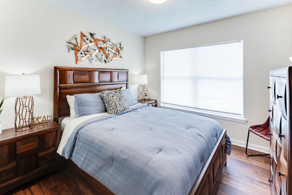 a bedroom with a large bed and a large window