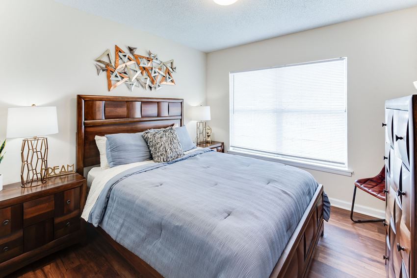 a bedroom with a large bed and a large window