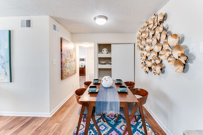 a dining room with a wooden table and chairs