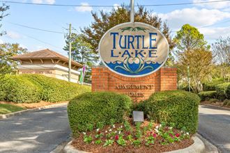 the sign for turtle lake at the entrance to turtle lake apartments