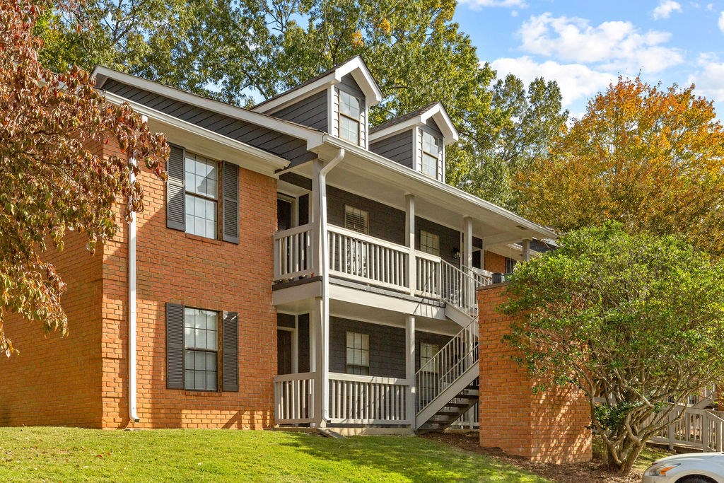 a red brick apartment building with a porch and balconies