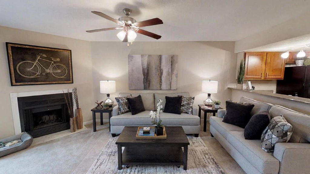 a living room with furniture and a ceiling fan