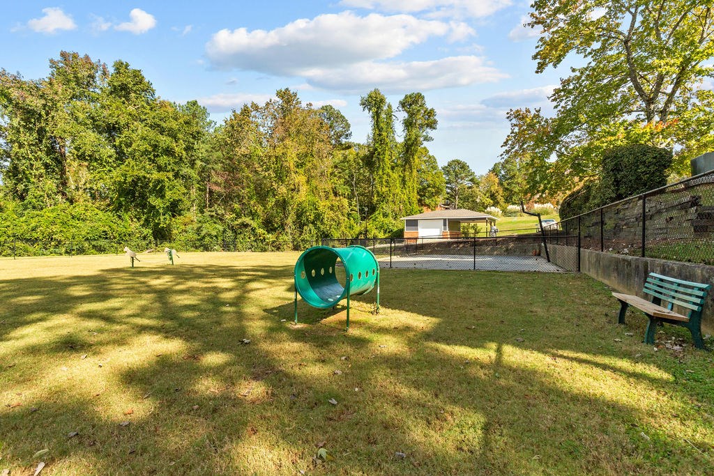 a park with a bench and a tennis court