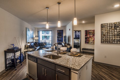 view of living room from kitchen with granite counter top and kitchen island and living room