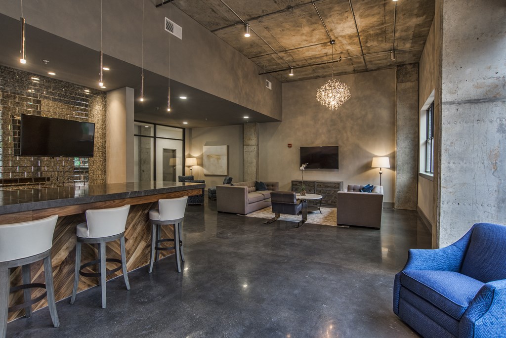 a living room with a bar and couches