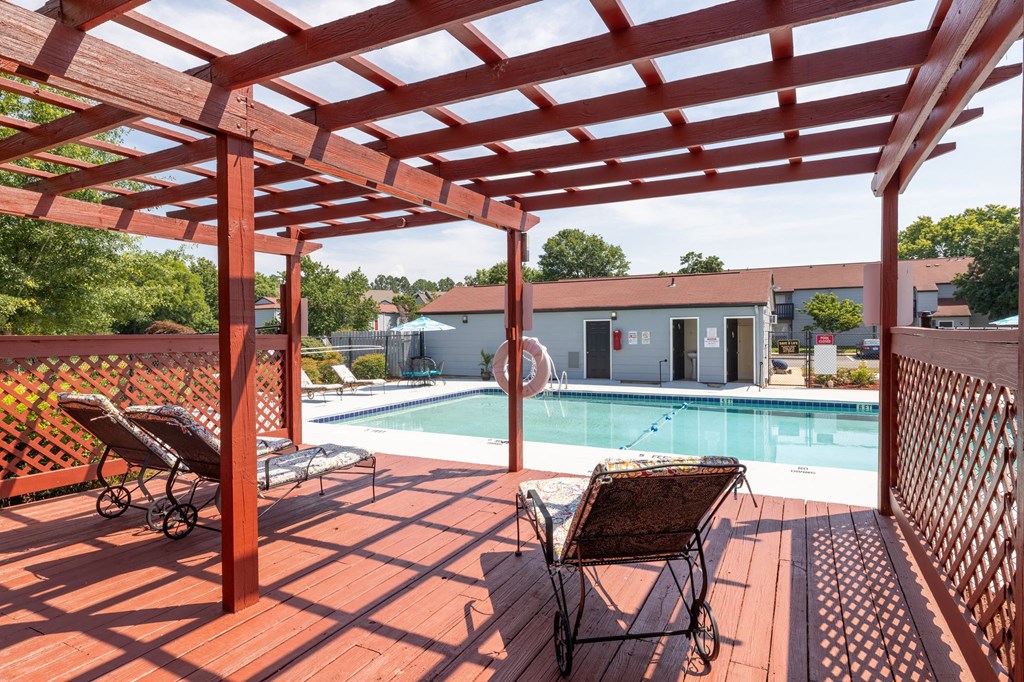 our apartments have a large pool and a deck with chairs