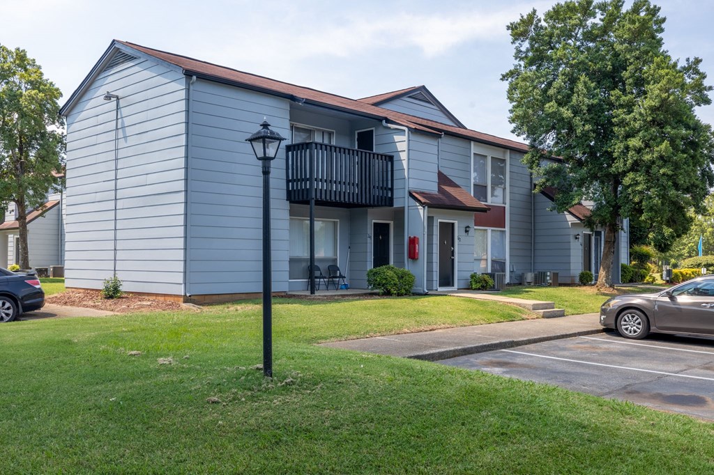 a blue building with a balcony and a street light