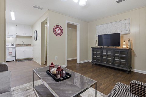 A living room with a grey coffee table and a grey sofa.