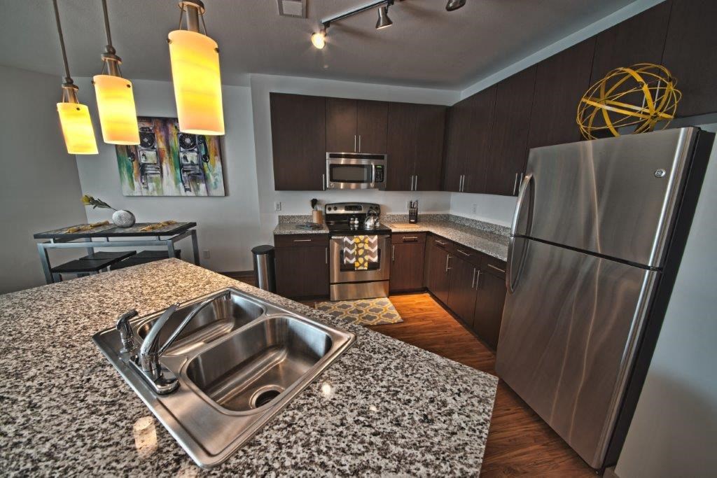 a kitchen with stainless steel appliances and granite counter tops