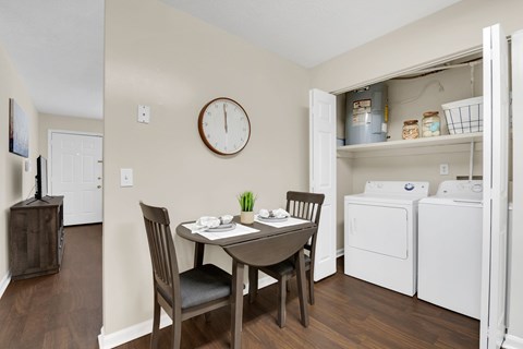 A small dining room with a table and chairs.