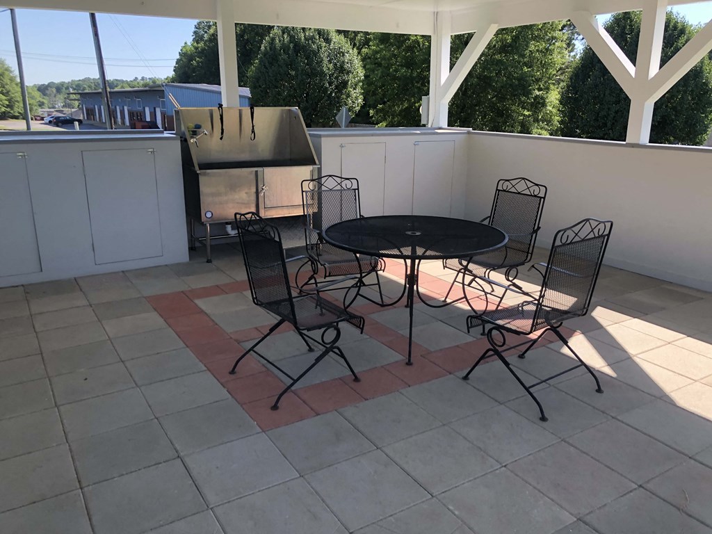 a patio with a table and chairs on a roof