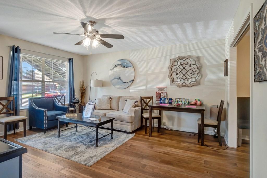 A living room with a white ceiling fan and a white couch.