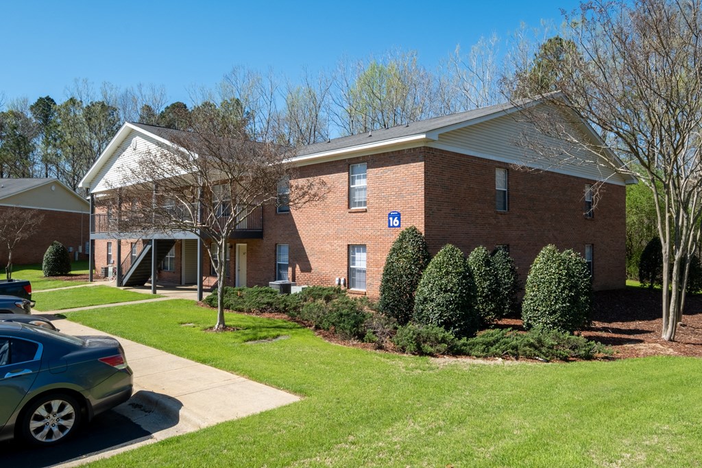 A brick building with a blue sign on it.
