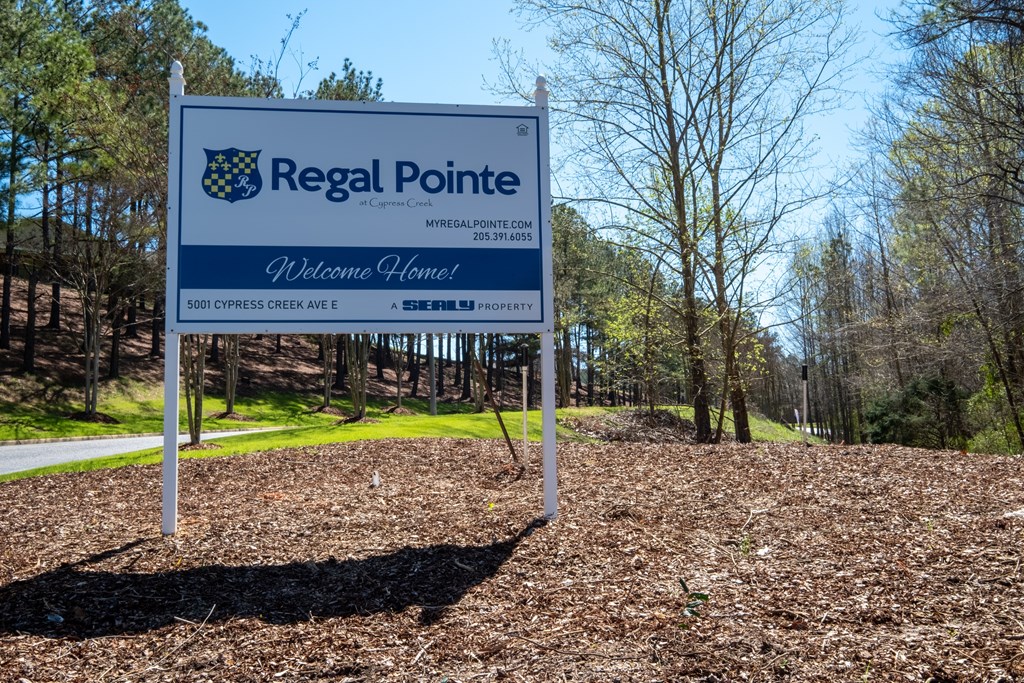 A blue and white sign welcoming people to Regal Pointe.