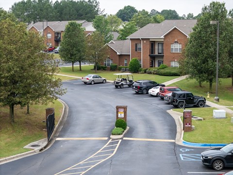 a parking lot with cars parked in front of houses