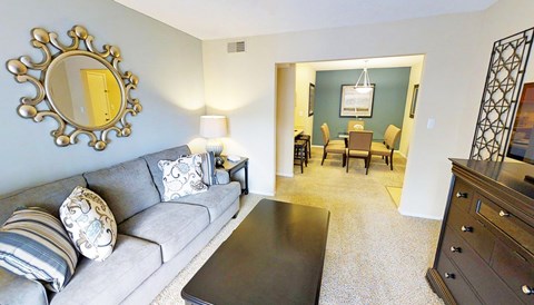 A living room with a grey couch and a coffee table.