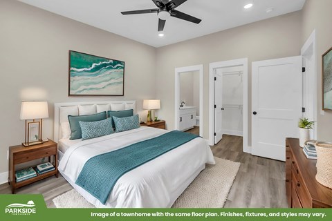 A bedroom with a bed, nightstands, and a painting on the wall.