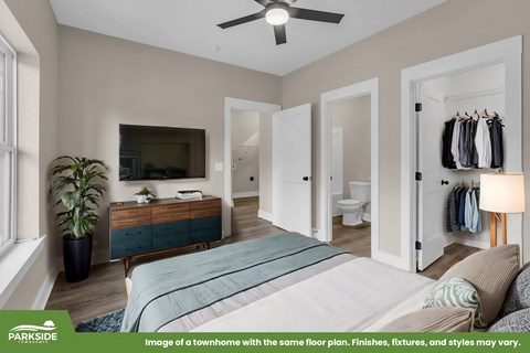 A bedroom with a bed, dresser, and mirror.